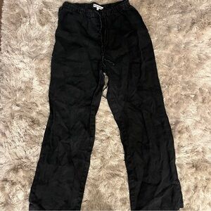 Reformation black linen wide-leg pants featuring a drawstring waist